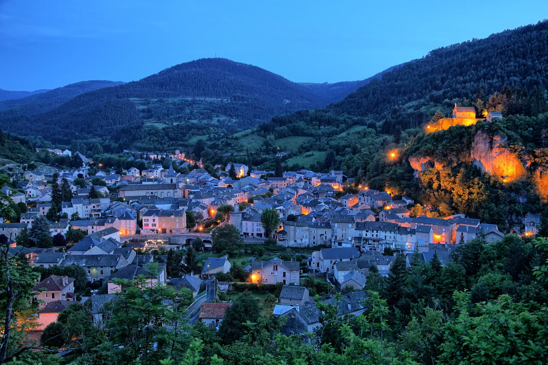 Vue aérienne d'une petite ville française nichée dans une vallée en fin de journée